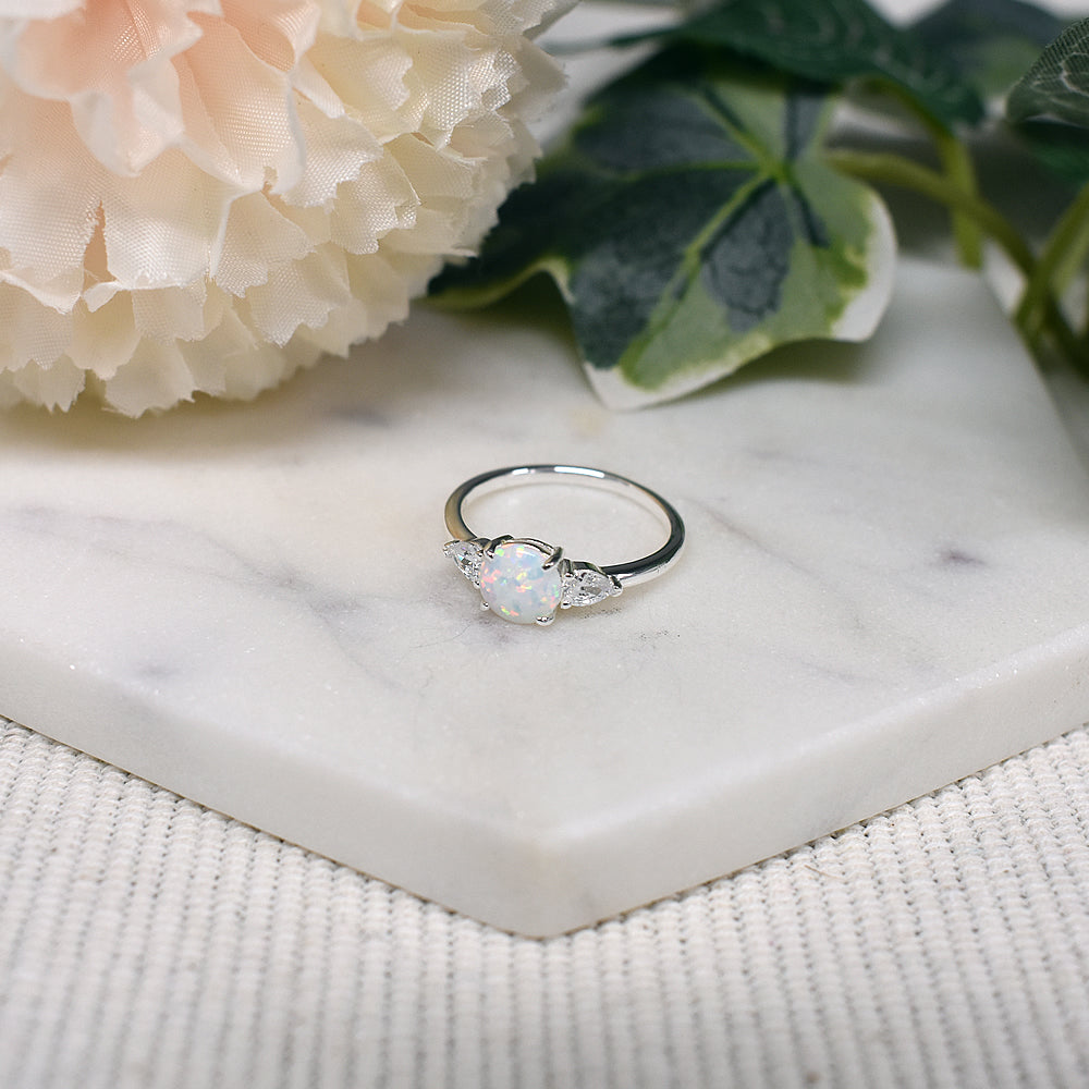 Bethan round white opalique with teardrop CZ shoulder ring